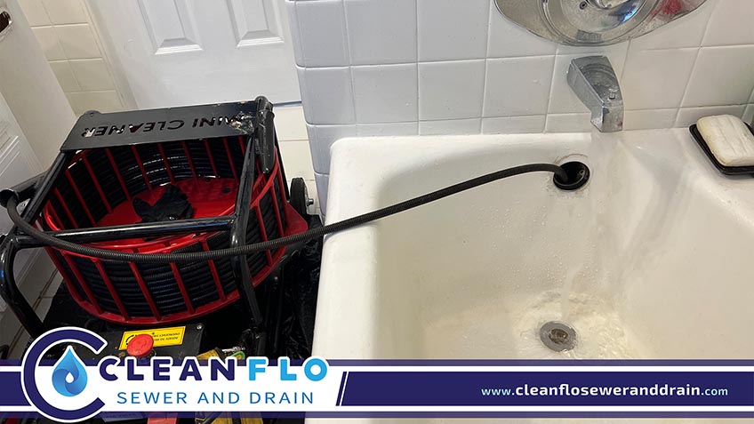 Drain Cleaning Equipment Unclogging a Bathtub